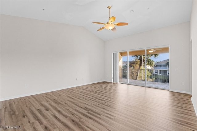 spare room with ceiling fan, vaulted ceiling, and light hardwood / wood-style flooring