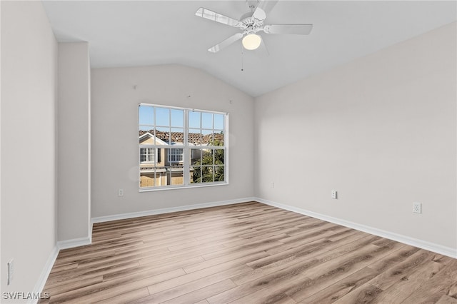 spare room featuring ceiling fan, light hardwood / wood-style floors, and vaulted ceiling