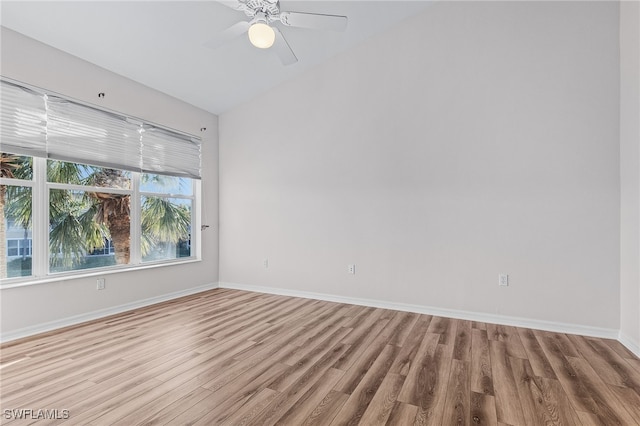 empty room featuring ceiling fan, light hardwood / wood-style floors, and vaulted ceiling