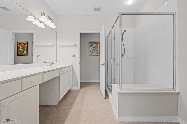 bathroom with tile patterned flooring, vanity, and a shower with shower door