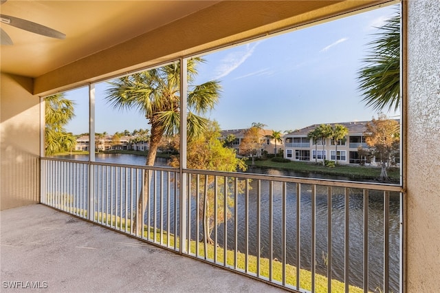 balcony with a water view and ceiling fan