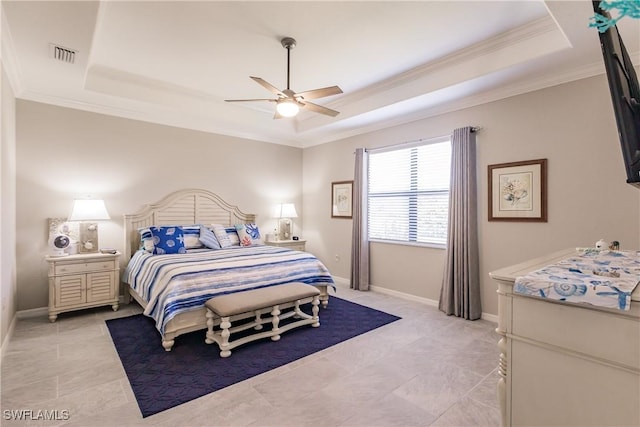 bedroom with ceiling fan, a raised ceiling, and crown molding