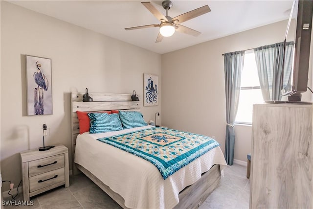 tiled bedroom featuring ceiling fan