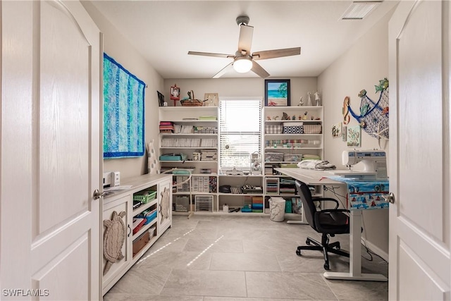 tiled office featuring ceiling fan