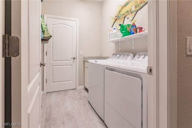 laundry room with cabinets and washing machine and dryer