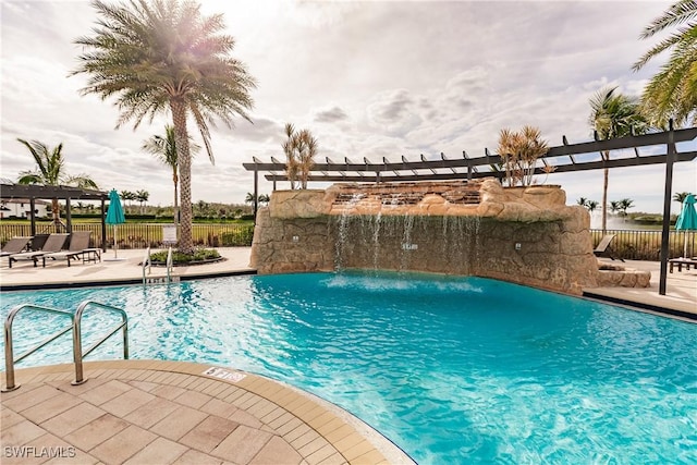 view of swimming pool with pool water feature and a patio