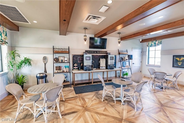 dining room with beamed ceiling and light parquet floors