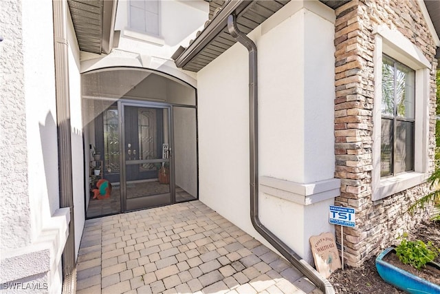 11973 Bay Oak Dr, Fort Myers, FL 33913 - view of exterior entry featuring stucco siding and stone siding