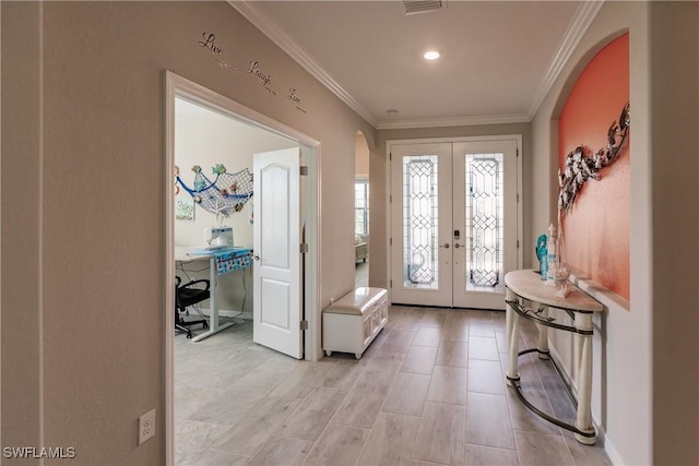 foyer featuring crown molding and french doors