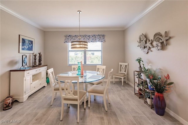 dining space with crown molding and a chandelier