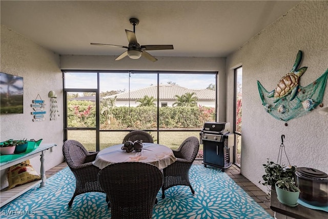 sunroom featuring ceiling fan