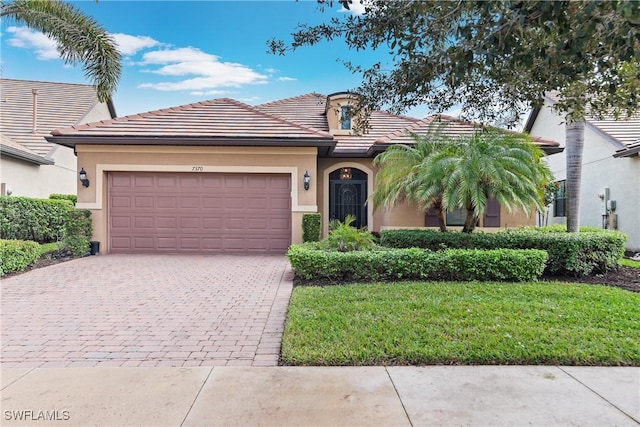 view of front of house featuring a garage and a front lawn