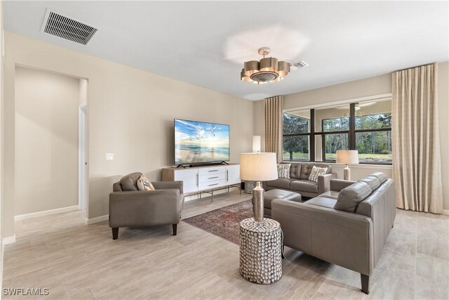 living room featuring a chandelier and light hardwood / wood-style flooring