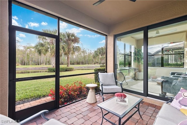 sunroom / solarium featuring ceiling fan