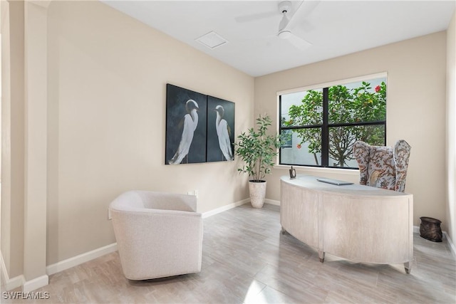 sitting room featuring ceiling fan