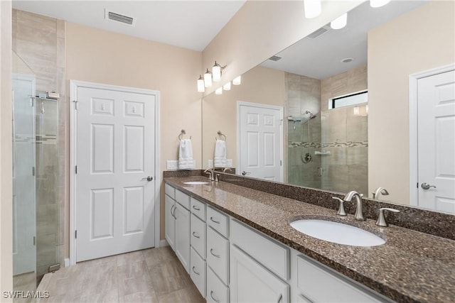 bathroom with walk in shower and vanity