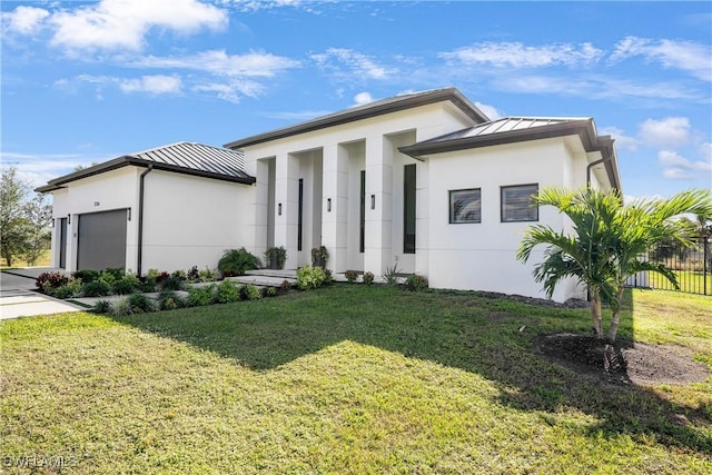 view of front of house featuring a front yard and a garage