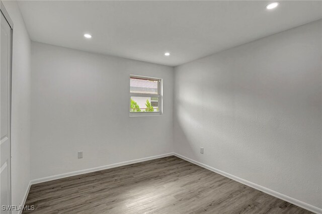 spare room featuring dark hardwood / wood-style flooring