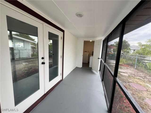 sunroom / solarium featuring french doors and washer and clothes dryer