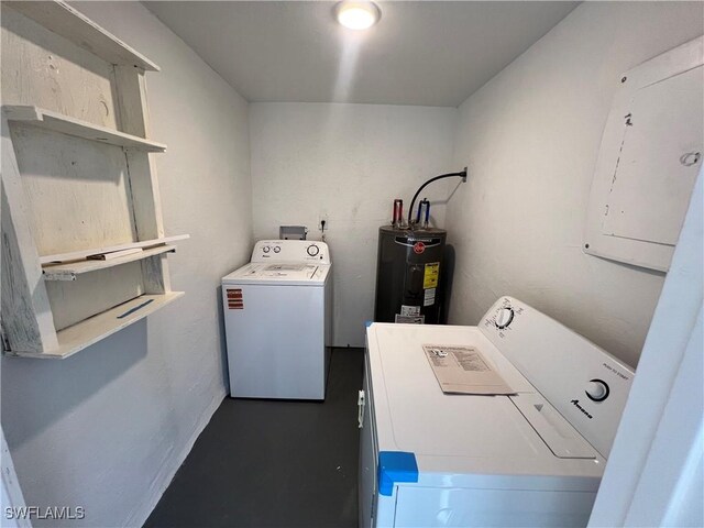 laundry area featuring electric panel, washer and clothes dryer, and water heater