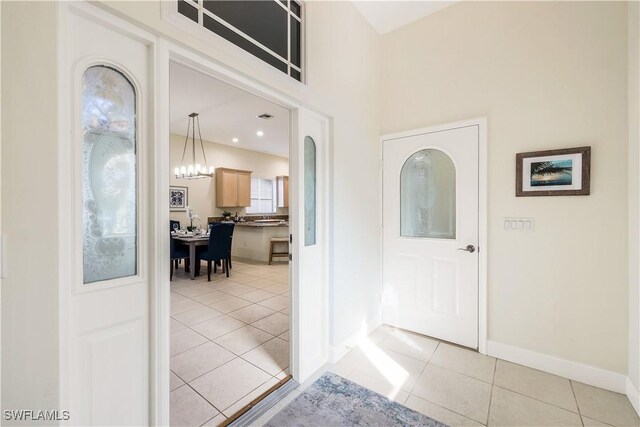 tiled entrance foyer featuring a chandelier