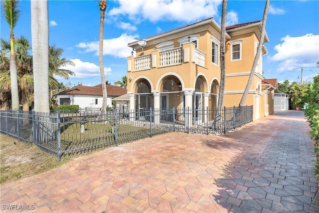 mediterranean / spanish-style house with a balcony