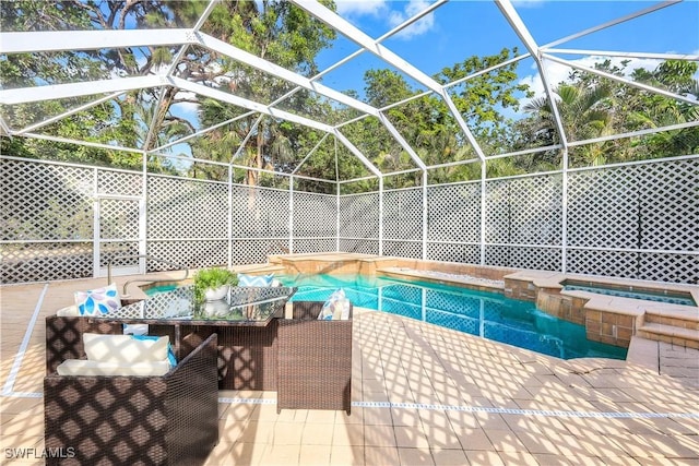 view of pool featuring an outdoor living space, a patio, glass enclosure, and an in ground hot tub