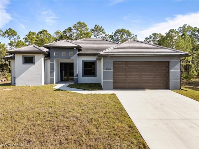 view of front of house featuring a front yard and a garage