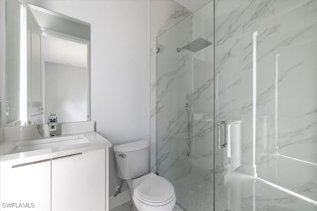 bathroom with walk in shower, vanity, and toilet