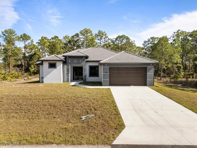 prairie-style house with a front lawn and a garage