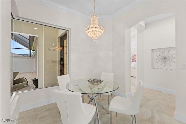 dining area featuring ornamental molding and an inviting chandelier