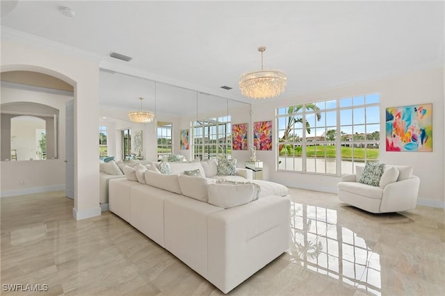 living room with ornamental molding and a chandelier