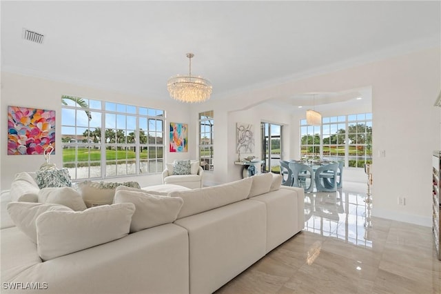 living room with a notable chandelier and crown molding