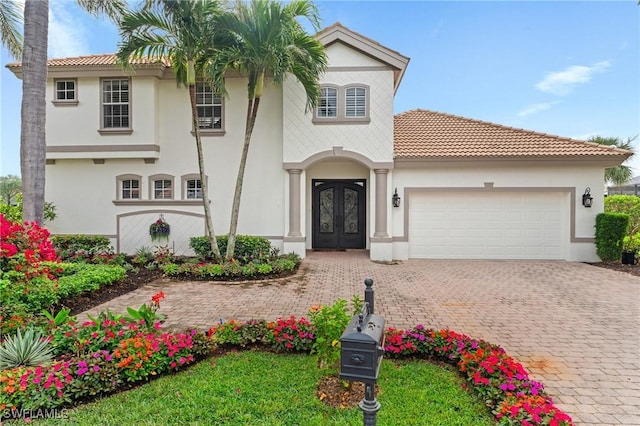 mediterranean / spanish-style house with french doors