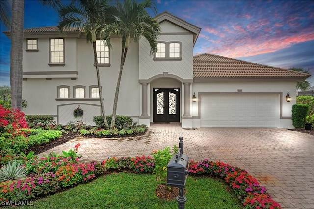 mediterranean / spanish-style home featuring a garage