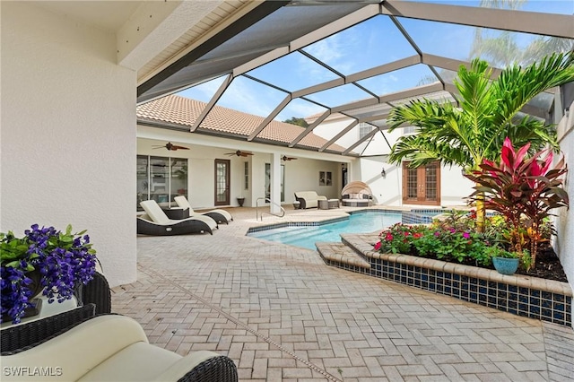 view of pool with a patio area, french doors, ceiling fan, and glass enclosure