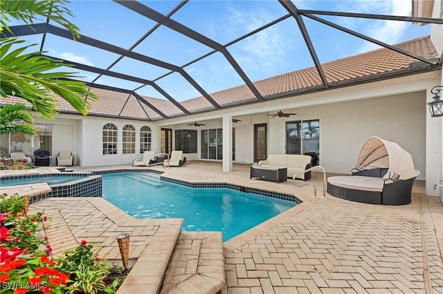 view of swimming pool featuring ceiling fan, an outdoor living space, a patio area, and glass enclosure