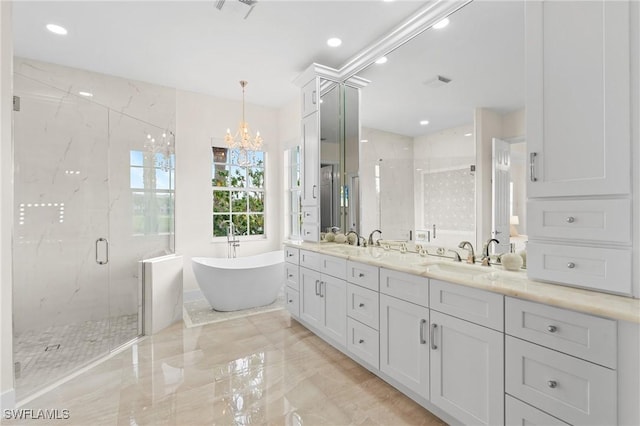 bathroom featuring an inviting chandelier, vanity, and plus walk in shower