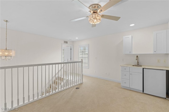 interior space featuring an inviting chandelier, light colored carpet, and sink