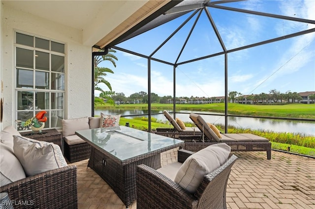 view of patio featuring an outdoor living space, glass enclosure, and a water view