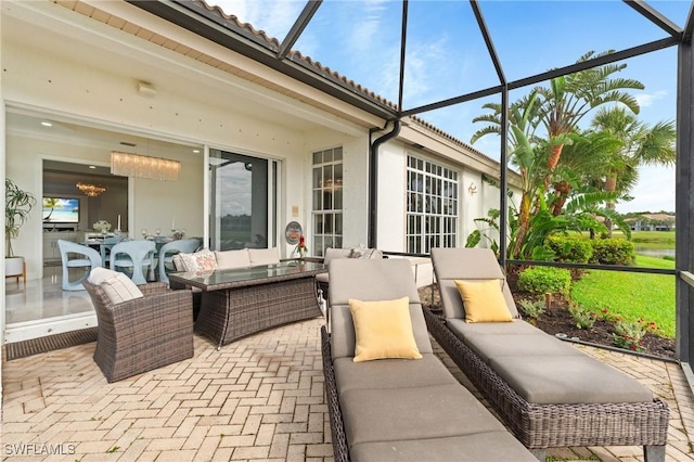 view of patio with an outdoor hangout area and glass enclosure