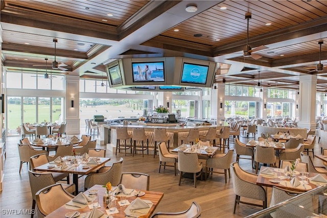 dining space with wood ceiling, ceiling fan, coffered ceiling, light hardwood / wood-style floors, and beamed ceiling