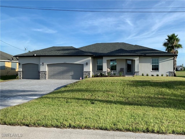 view of front of home featuring a front yard and a garage