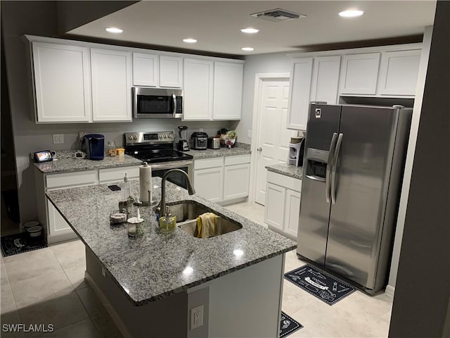 kitchen with white cabinetry, sink, an island with sink, and appliances with stainless steel finishes