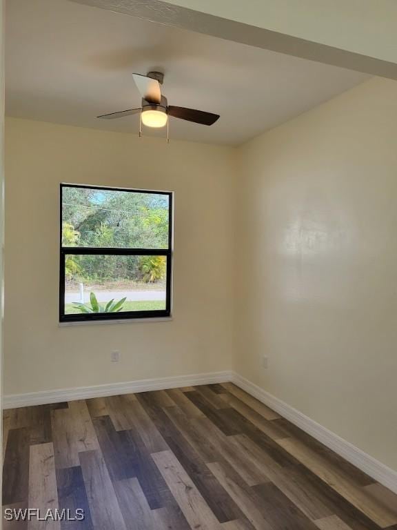 spare room featuring ceiling fan and dark hardwood / wood-style floors