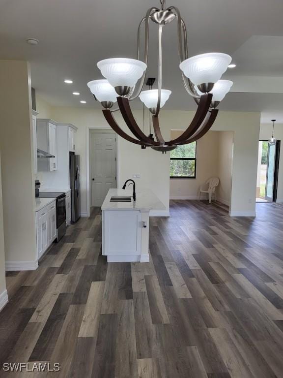 kitchen featuring electric range, white cabinetry, stainless steel refrigerator, and a chandelier