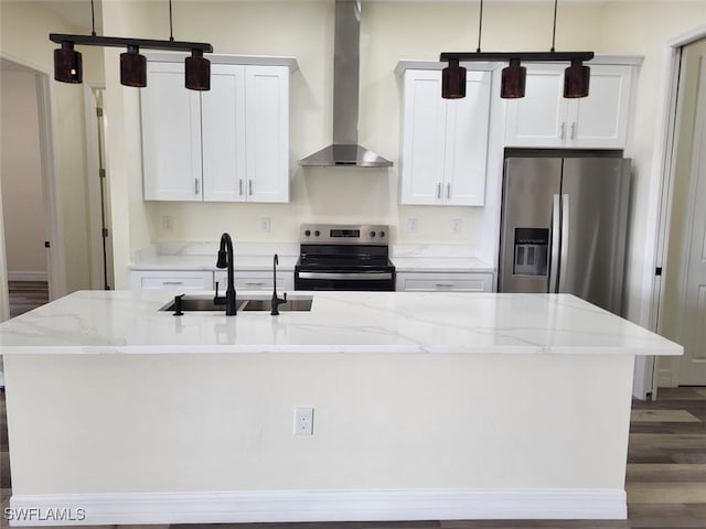 kitchen featuring white cabinets, wall chimney exhaust hood, an island with sink, and appliances with stainless steel finishes