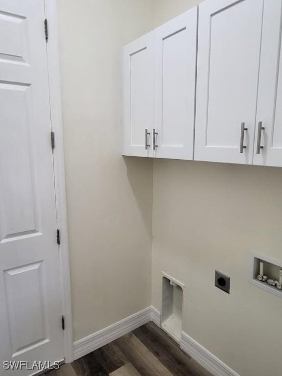 laundry area featuring electric dryer hookup, dark hardwood / wood-style flooring, cabinets, and washer hookup