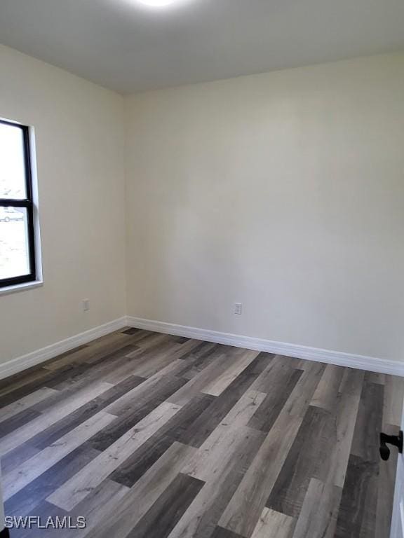 spare room with dark hardwood / wood-style floors