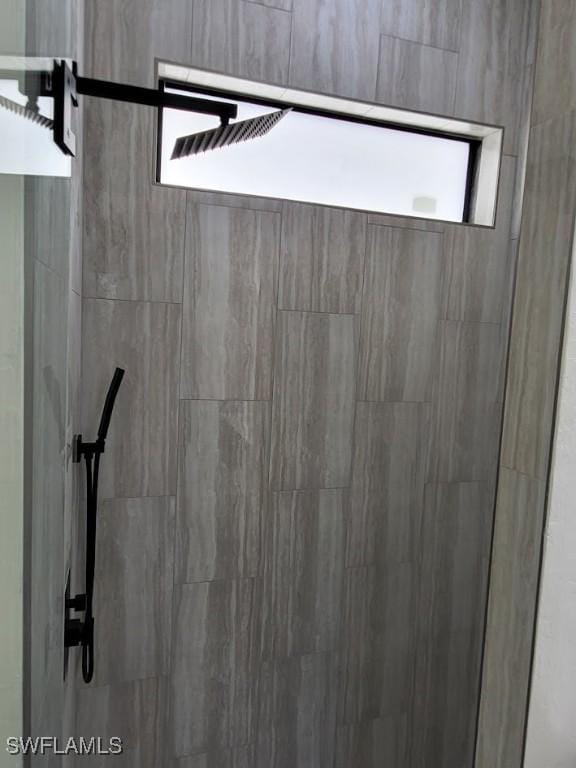 interior details featuring a tile shower